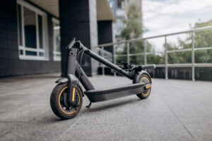 folded black electric scooter outside on city street